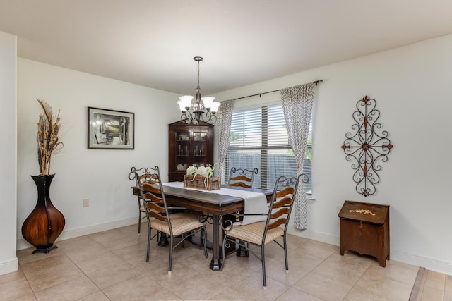 dining area featuring light tile patterned floors and a notable chandelier