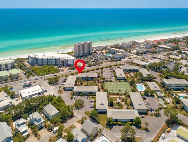 drone / aerial view with a water view and a beach view