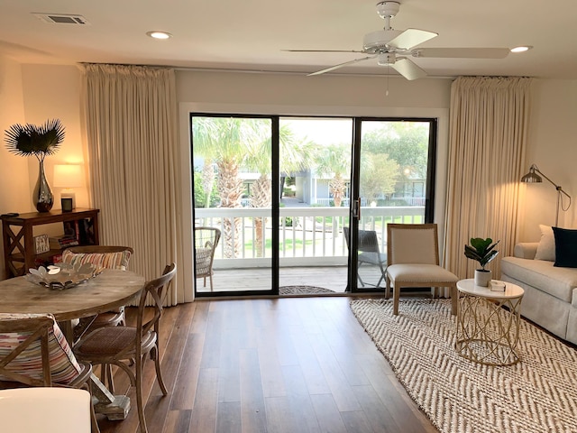 living room with hardwood / wood-style flooring and ceiling fan