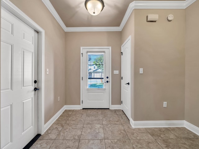 foyer with crown molding and light tile patterned floors