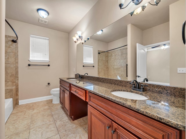 bathroom with tile patterned flooring, vanity, toilet, and plenty of natural light