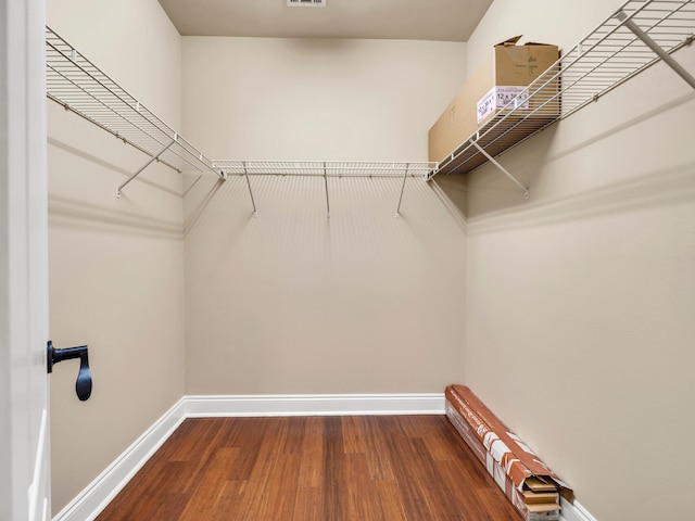 walk in closet with wood-type flooring