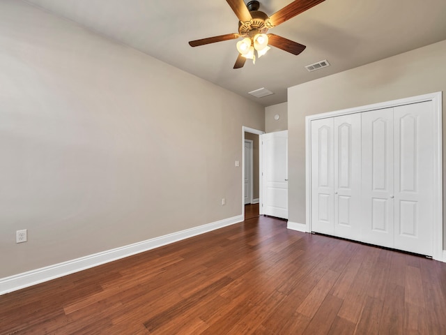 unfurnished bedroom featuring a closet, dark hardwood / wood-style floors, and ceiling fan