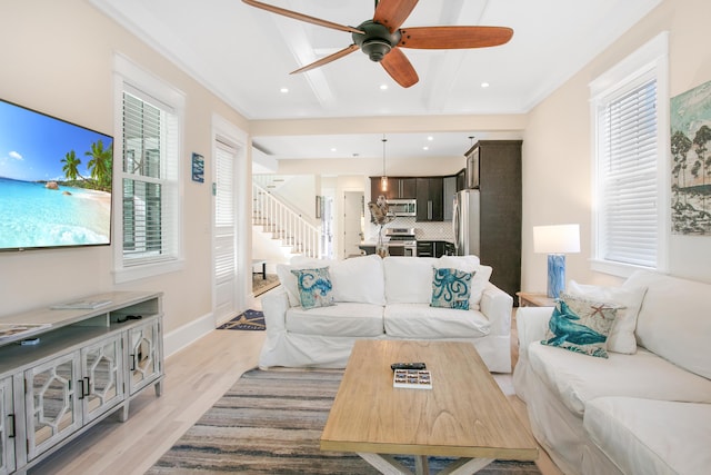 living room with ceiling fan and light wood-type flooring