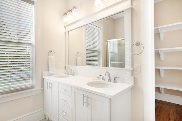 bathroom featuring hardwood / wood-style flooring, vanity, and an enclosed shower