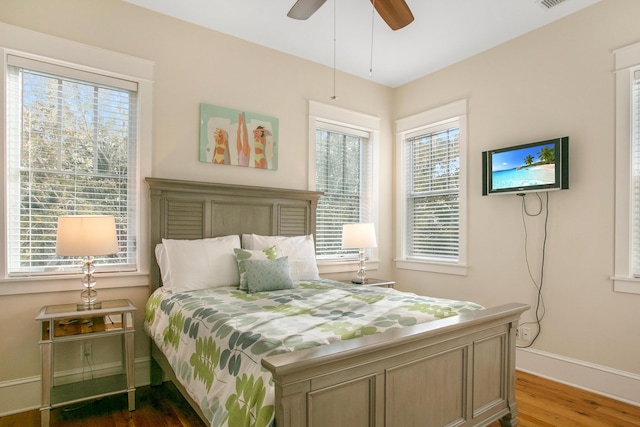 bedroom with ceiling fan and dark hardwood / wood-style floors