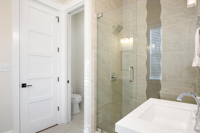 bathroom with tile patterned floors, toilet, walk in shower, and sink