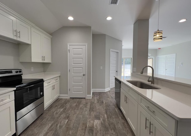 kitchen with stainless steel appliances, light countertops, a sink, and dark wood-style floors