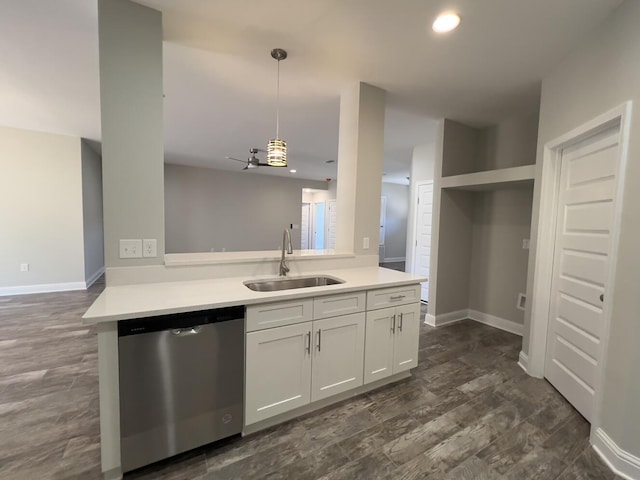 kitchen featuring a sink, white cabinetry, open floor plan, light countertops, and dishwasher