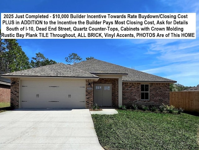 ranch-style home featuring brick siding, roof with shingles, concrete driveway, a front yard, and a garage