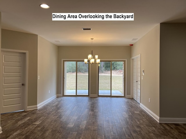 interior space featuring an inviting chandelier, baseboards, and dark wood-style flooring