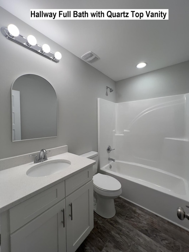 full bath featuring toilet, visible vents, tub / shower combination, and vanity