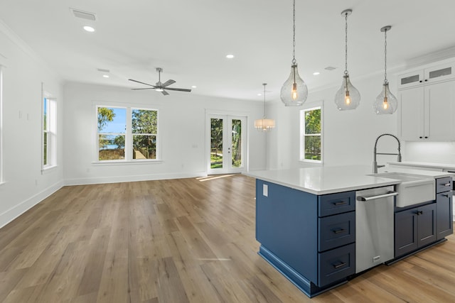 kitchen featuring sink, dishwasher, light hardwood / wood-style flooring, white cabinets, and ceiling fan with notable chandelier