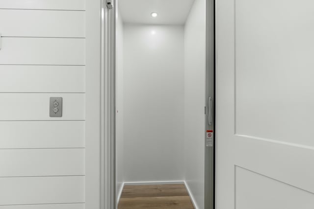 details featuring wood-type flooring and elevator