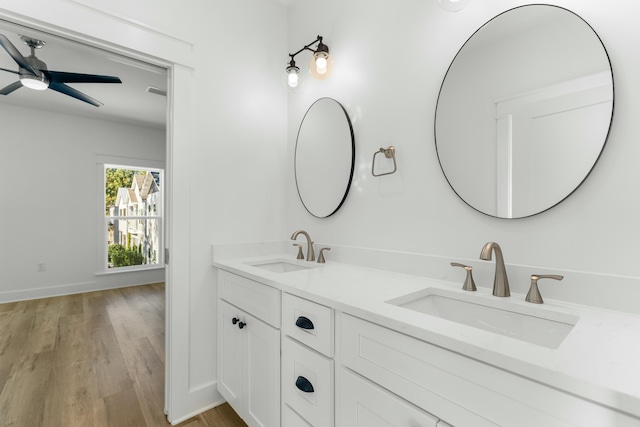 bathroom featuring wood-type flooring, vanity, and ceiling fan