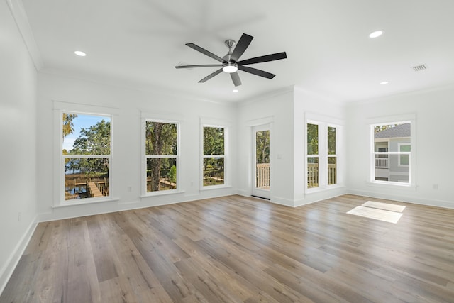 unfurnished sunroom with ceiling fan