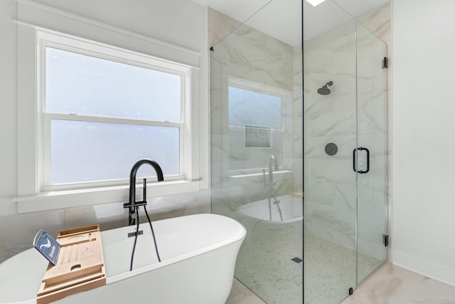 bathroom with plenty of natural light and independent shower and bath