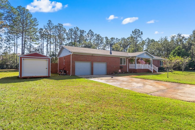 ranch-style home featuring a garage, covered porch, and a front yard