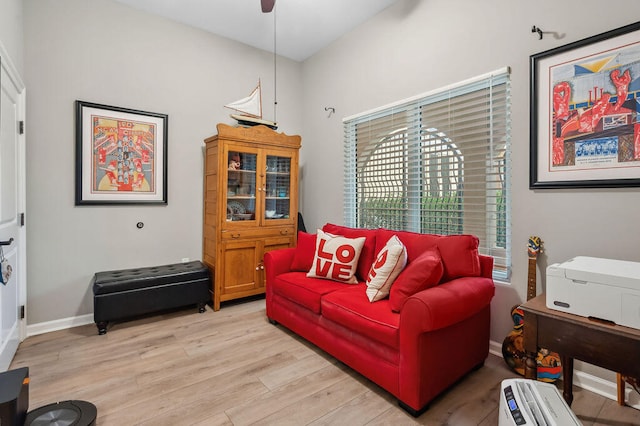 living room with ceiling fan and light hardwood / wood-style floors