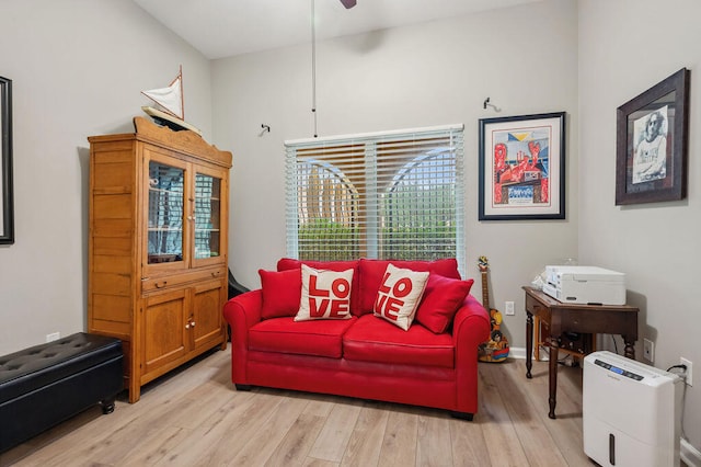 living room with light hardwood / wood-style floors and ceiling fan