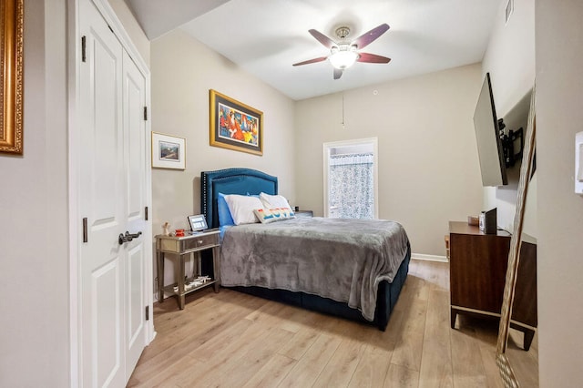 bedroom with ceiling fan, a closet, and light wood-type flooring