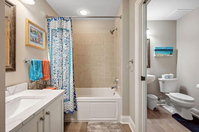 full bathroom with toilet, shower / tub combo with curtain, vanity, and hardwood / wood-style flooring