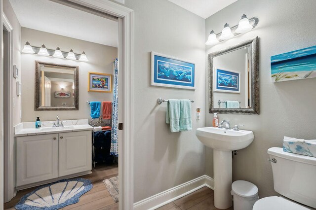 bathroom featuring hardwood / wood-style floors and toilet