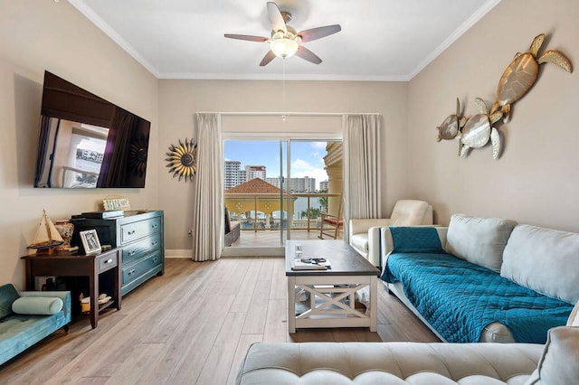 living room with light wood-type flooring, ceiling fan, and crown molding