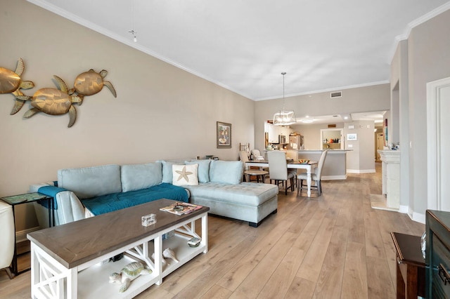 living room with light hardwood / wood-style floors and crown molding