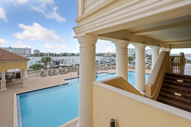 view of swimming pool featuring a water view