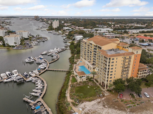 bird's eye view of a large body of water, a marina, and apartment complex / building
