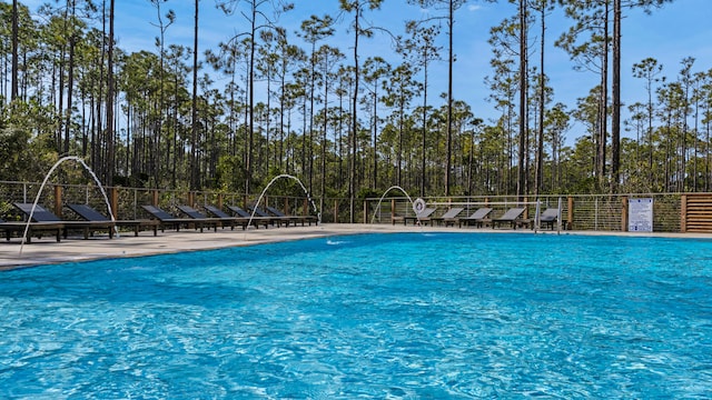 view of swimming pool featuring pool water feature