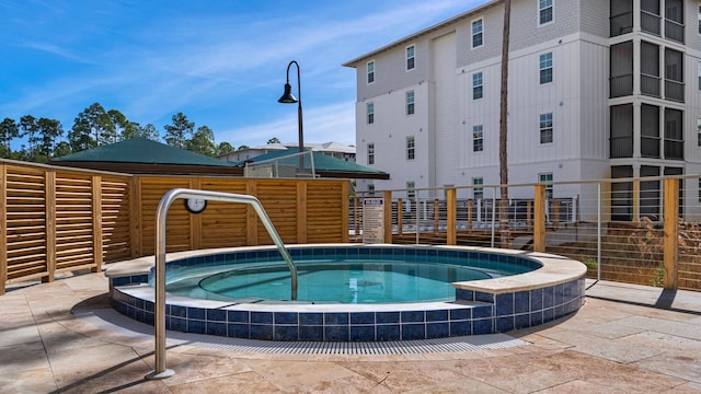 view of swimming pool featuring a community hot tub