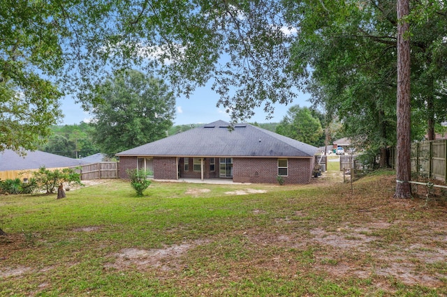 back of property featuring a yard and a patio