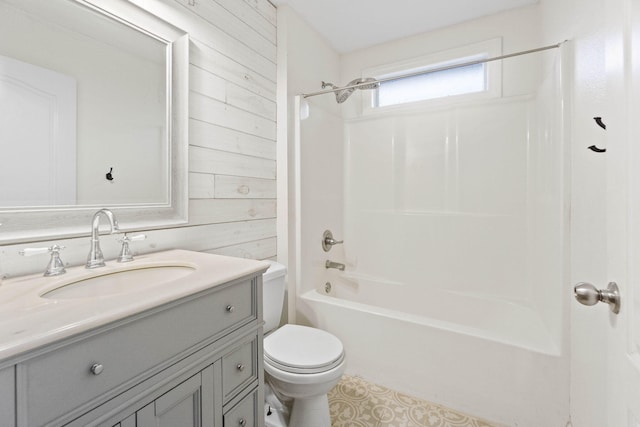 full bathroom with washtub / shower combination, vanity, toilet, and wooden walls