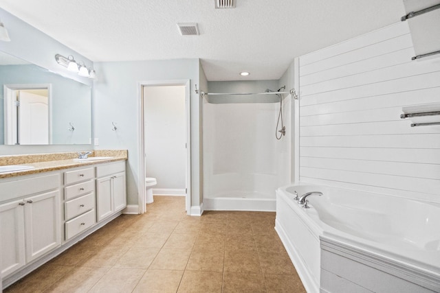 full bathroom with vanity, a textured ceiling, tile patterned flooring, shower with separate bathtub, and toilet