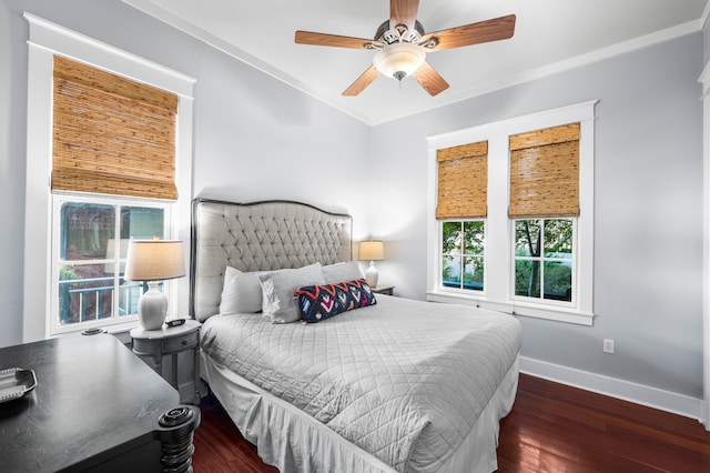 bedroom with dark hardwood / wood-style floors, ceiling fan, and ornamental molding