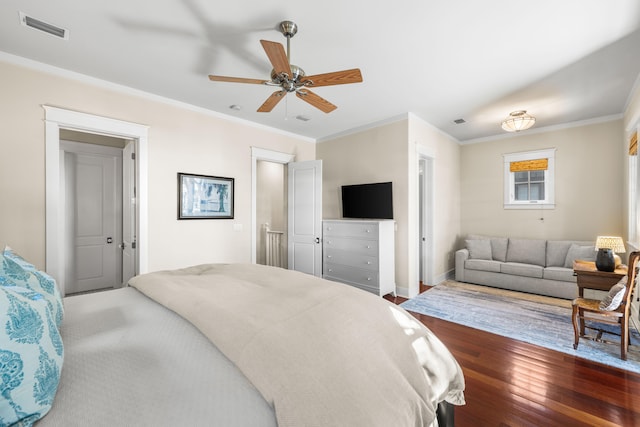 bedroom featuring ceiling fan, dark wood-type flooring, and ornamental molding