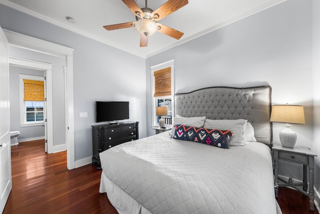 bedroom featuring ceiling fan, dark hardwood / wood-style flooring, and crown molding