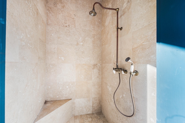 interior details featuring a tile shower