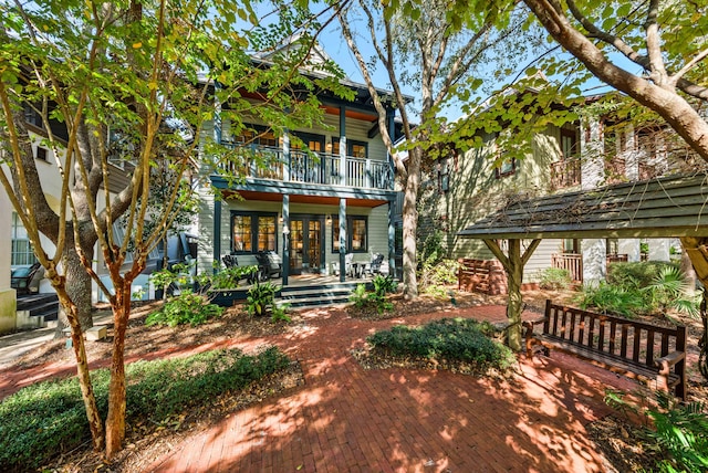 view of front of property with a porch, a balcony, and a pergola