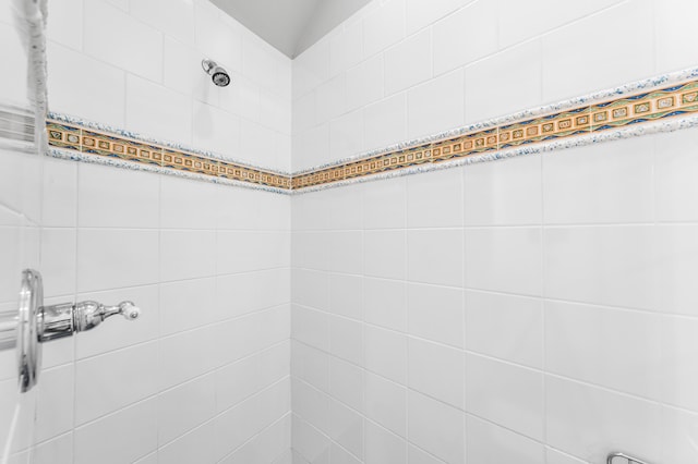 bathroom with tiled shower