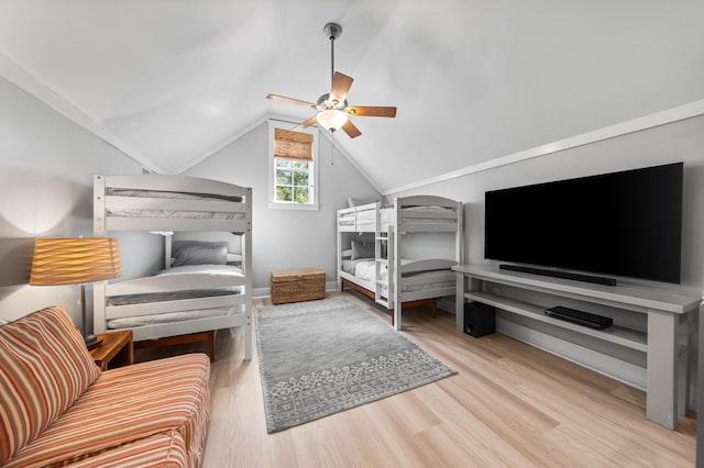 bedroom featuring ceiling fan, light hardwood / wood-style flooring, and lofted ceiling