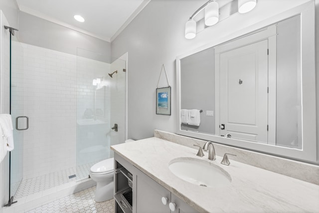 bathroom with tile patterned floors, crown molding, toilet, a shower with door, and vanity