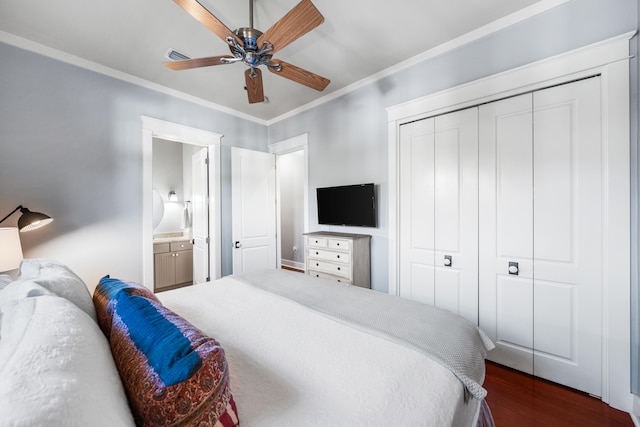 bedroom with ensuite bath, ceiling fan, dark hardwood / wood-style flooring, crown molding, and a closet