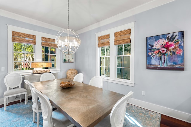 dining room with a chandelier, crown molding, and wood-type flooring