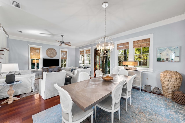 dining space with crown molding, ceiling fan with notable chandelier, and dark hardwood / wood-style floors