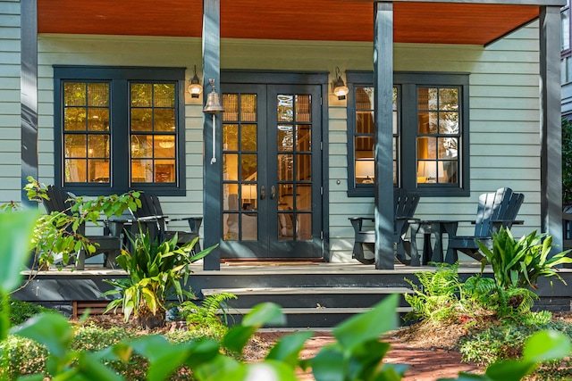 entrance to property with a porch and french doors