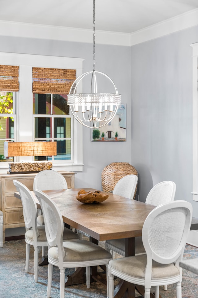 dining space featuring ornamental molding and an inviting chandelier