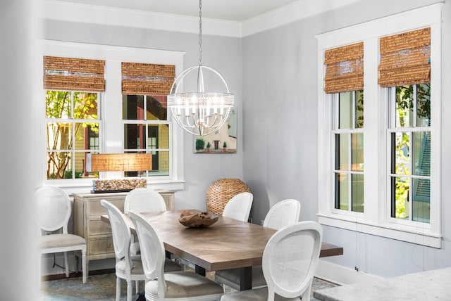 dining area with crown molding and a notable chandelier